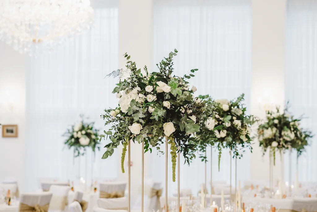 Elevated green and white wedding centrepieces by The Flower Story