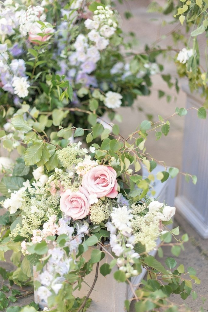 This unstructured look isn't only beautiful it is versatile. Think of it as a kind of montage of different size floral arrangements that can be moved, swapped around and re-positioned at different points of your day or event. 

For example this style