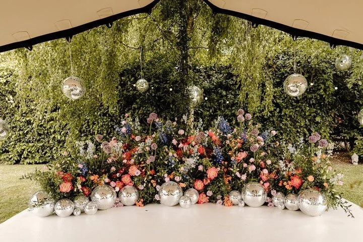Peonies, roses, alliums, delphiniums and disco balls came together to create a beautiful and fun ceremony meadow we can&rsquo;t stop daydreaming about. For the lovely K&amp;L&rsquo;s wedding.
⠀⠀⠀⠀⠀⠀⠀⠀⠀
Images @Steph.Kiely.Weddings
⠀⠀⠀⠀⠀⠀⠀⠀⠀
#LuxuryWe