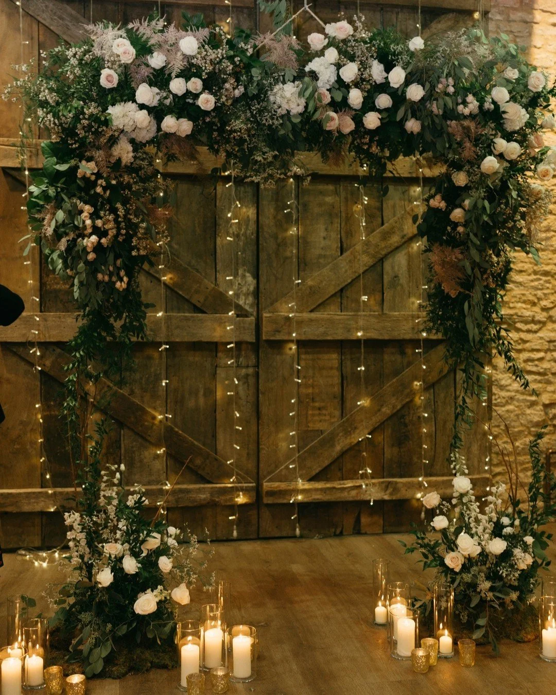 Hanging flower arch filled with garden roses and hydrangea with matching meadows for our lovely couple L&amp;S 

Venue @tythebarnlaunton
Images by @vandersteenphotography