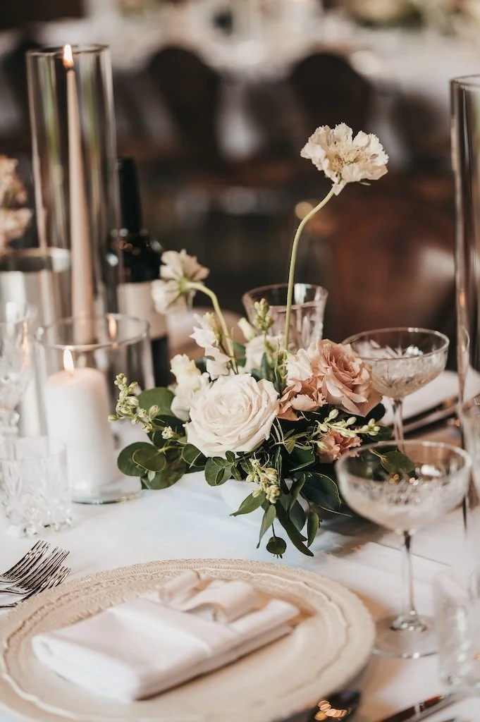 Small garden style white and neutral wedding flower centrepieces