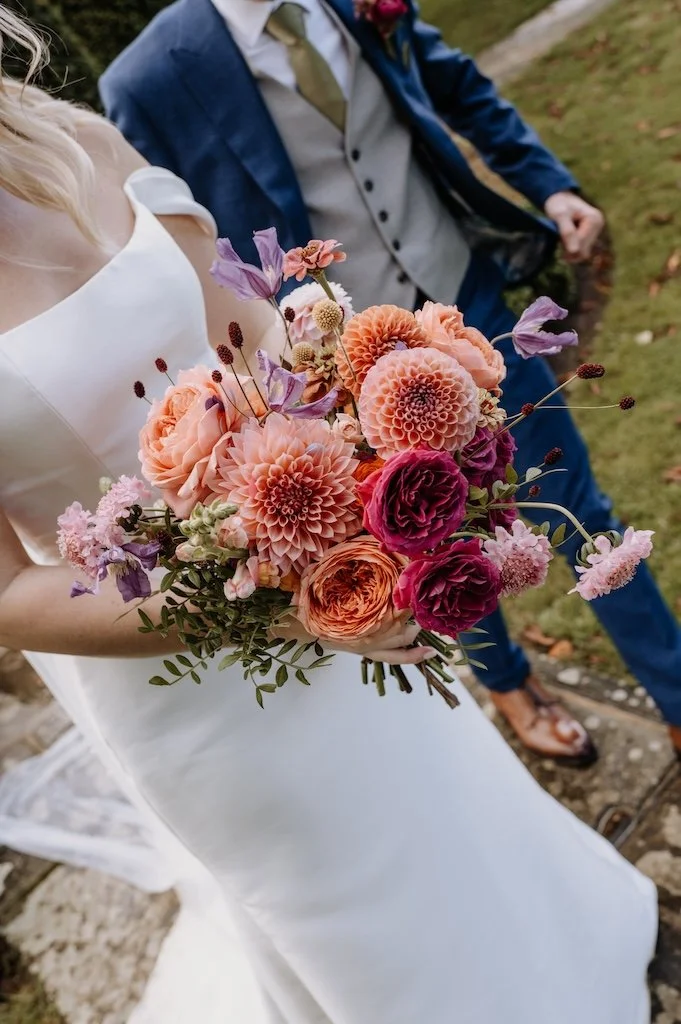 Colourful wedding bouquet full of garden roses dahlias and scabious