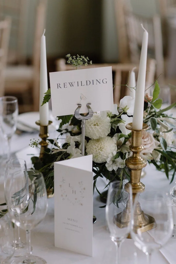 A garden style wedding flower centrepieces at Kelmarsh Hall by The Flower Story