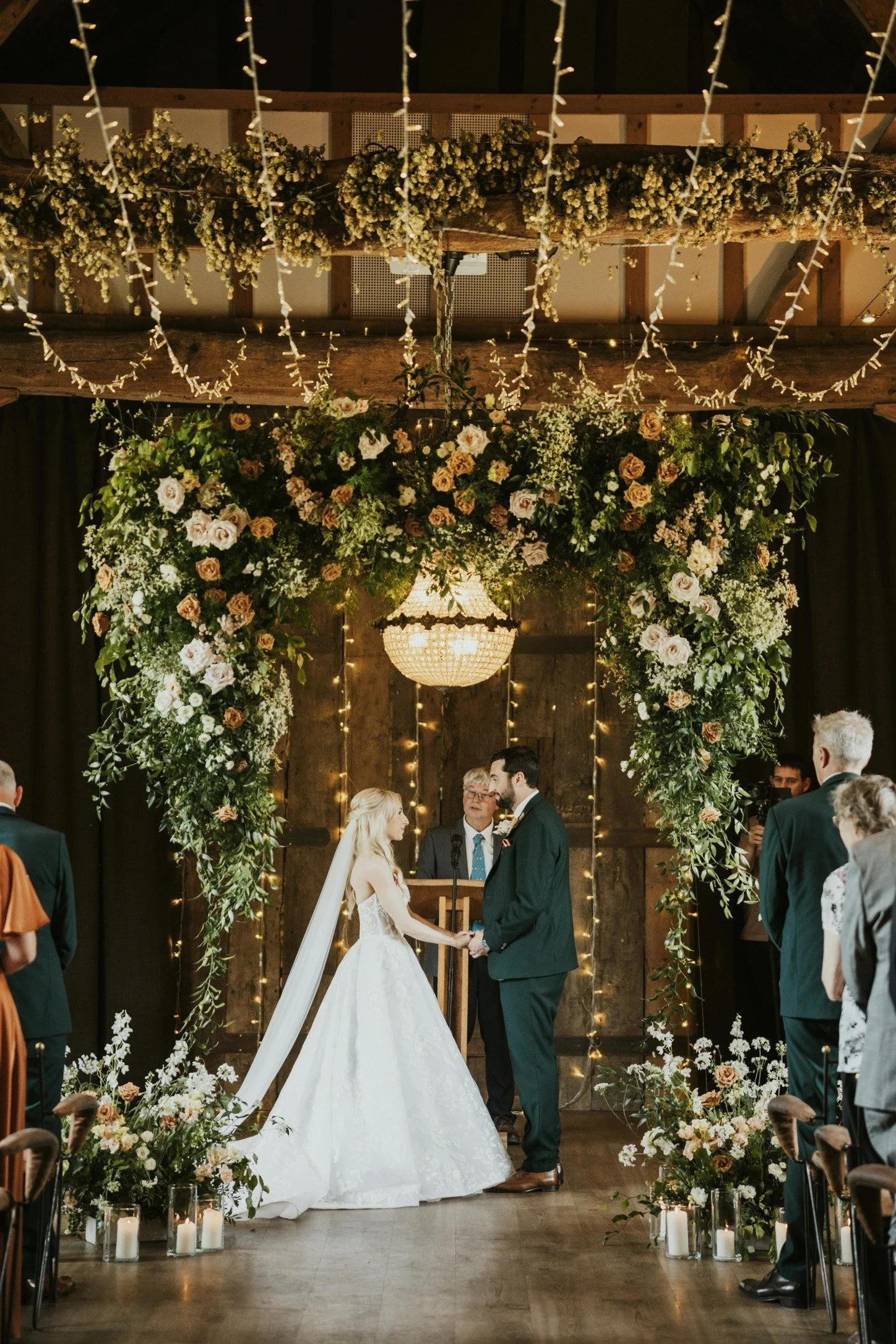 White, peach and terracotta wedding flower arch by The Flower Story