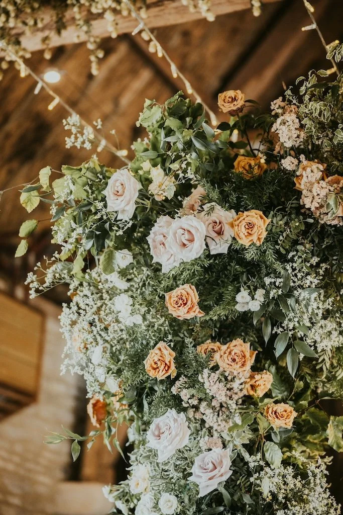 White, peach and terracotta wedding flower arch by The Flower Story