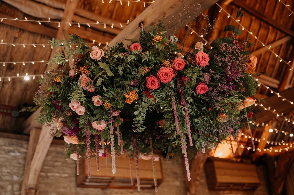 Large hanging foliage and flower hoop for wedding reception