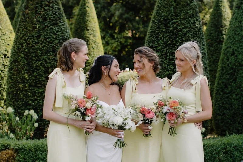 Bride and her bridesmaids holding their wedding bouquets by The Flower Story