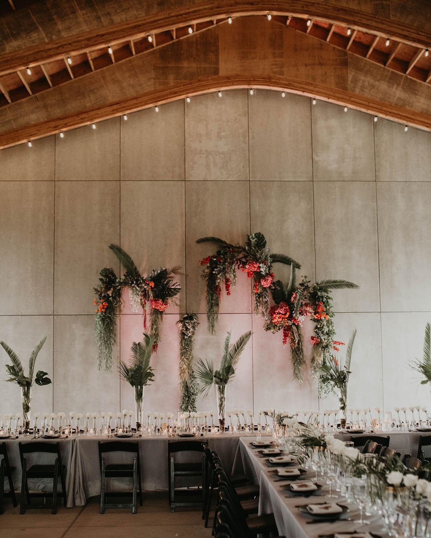 Just got a few sneak peeks in my inbox from @cheyannadenicolaphoto from Michelle + Eric&rsquo;s wedding love bash @gathergreene last weekend and I still can&rsquo;t get over this space! 450 bud jars &amp; roses, 32 palm vases, 400 votives, 62 floatin