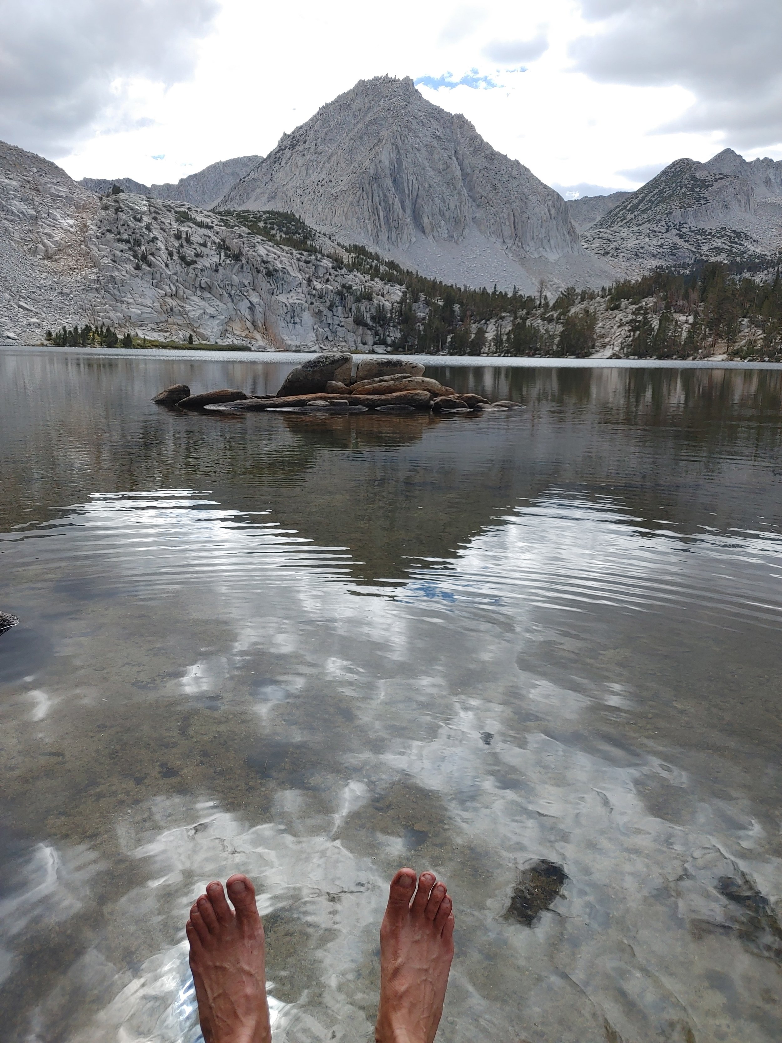  I have reached my destination. The lake is COLD. No real surprise being ~12,000 feet above sea level!  Look at those dirty feet! The fine silt really works its way in through the shoes and socks up here! 