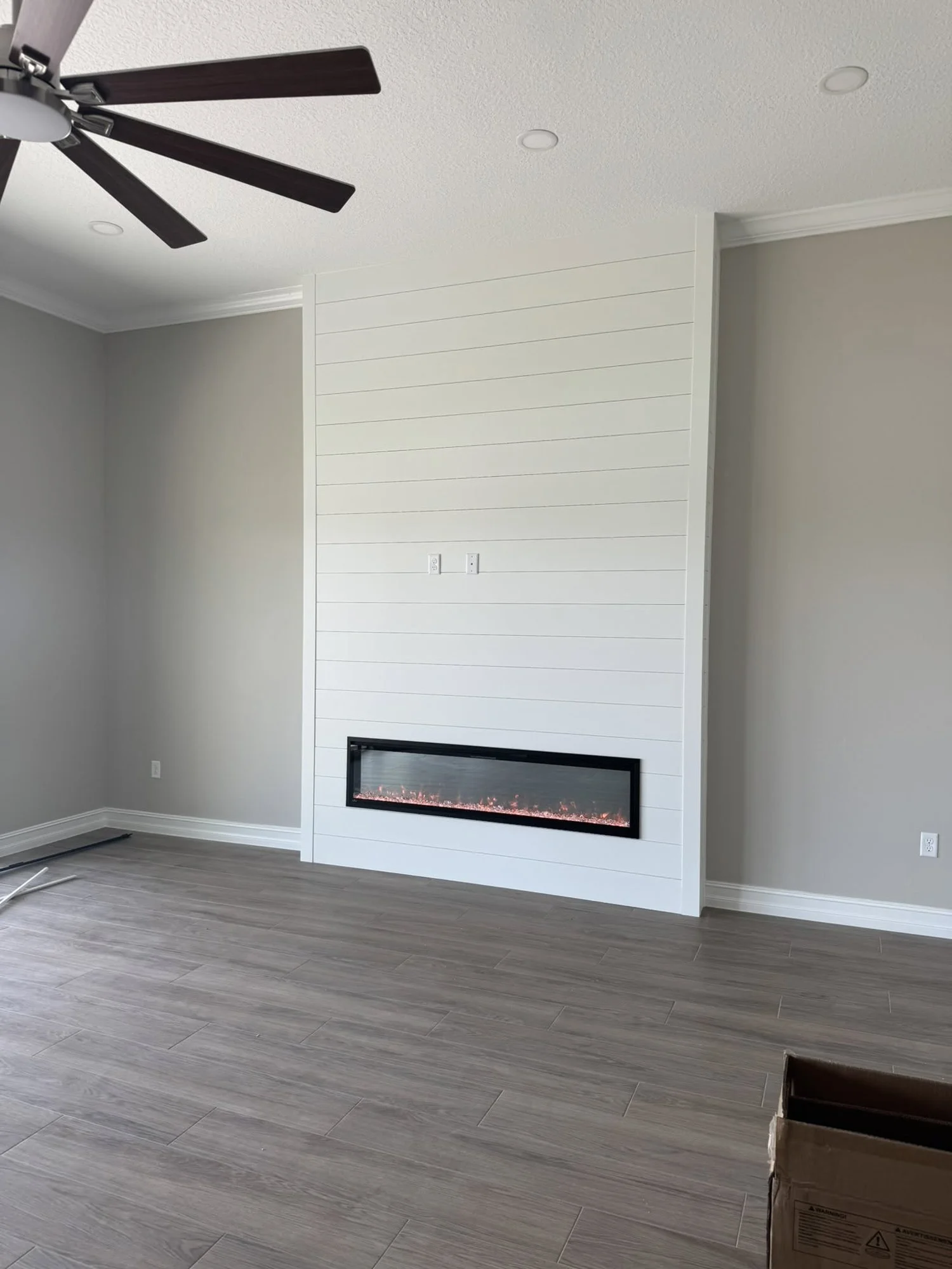 Shiplap fireplace accent wall with linear electric fireplace