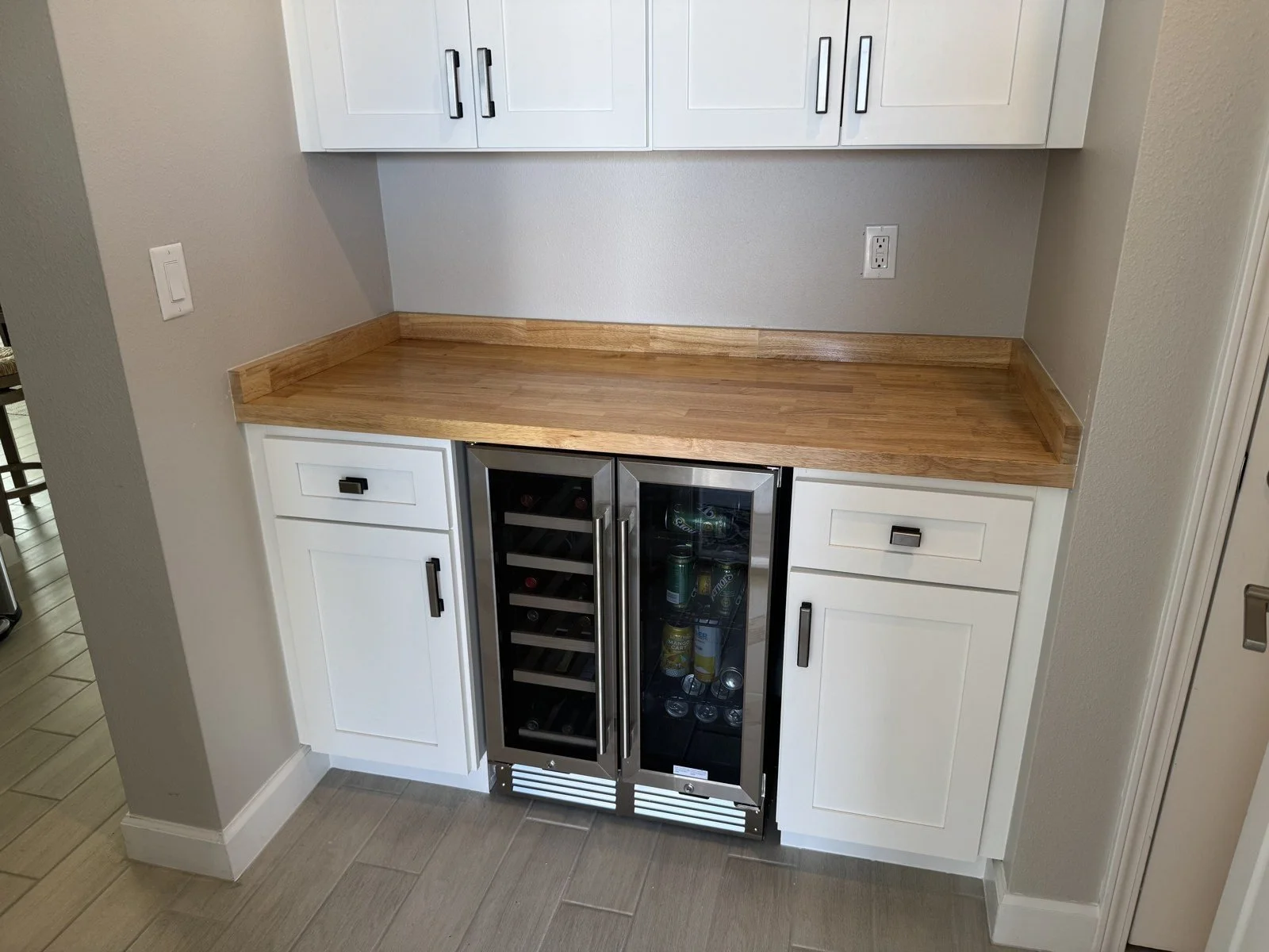 Butcher-block bar counter with wine fridge and shaker drawers
