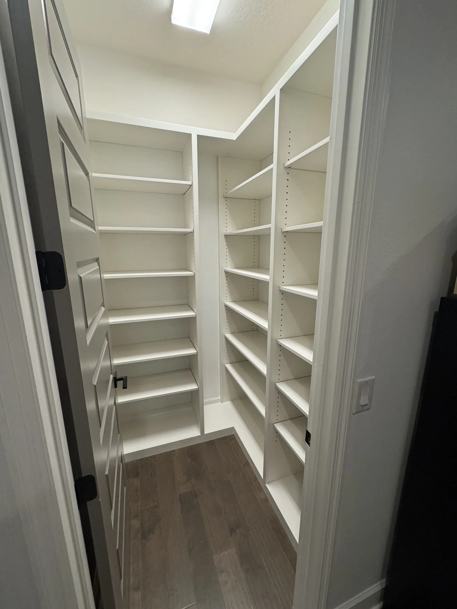 White floor-to-ceiling walk-in shelving