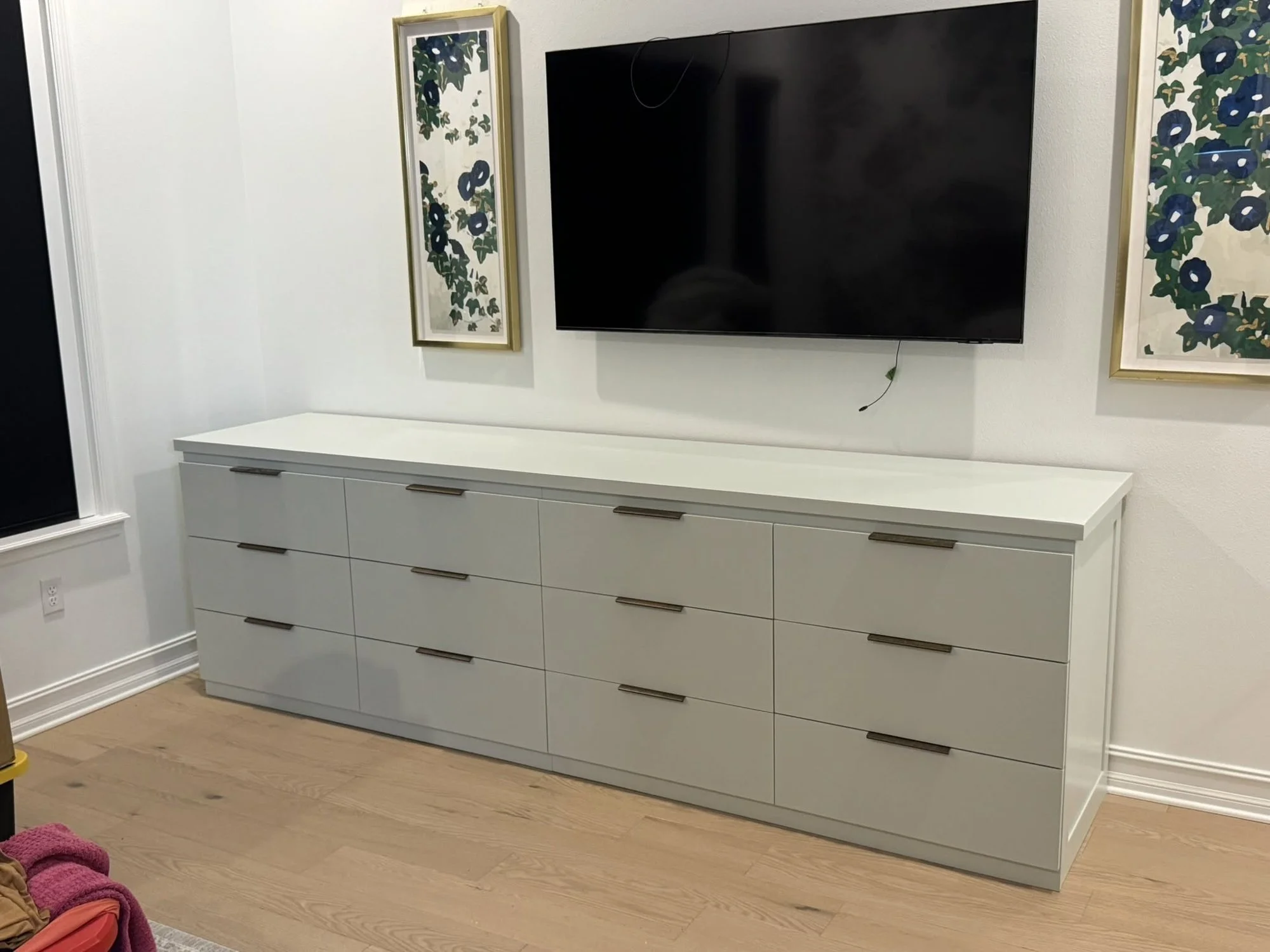 Built-in drawer cabinets under a wall-mounted TV