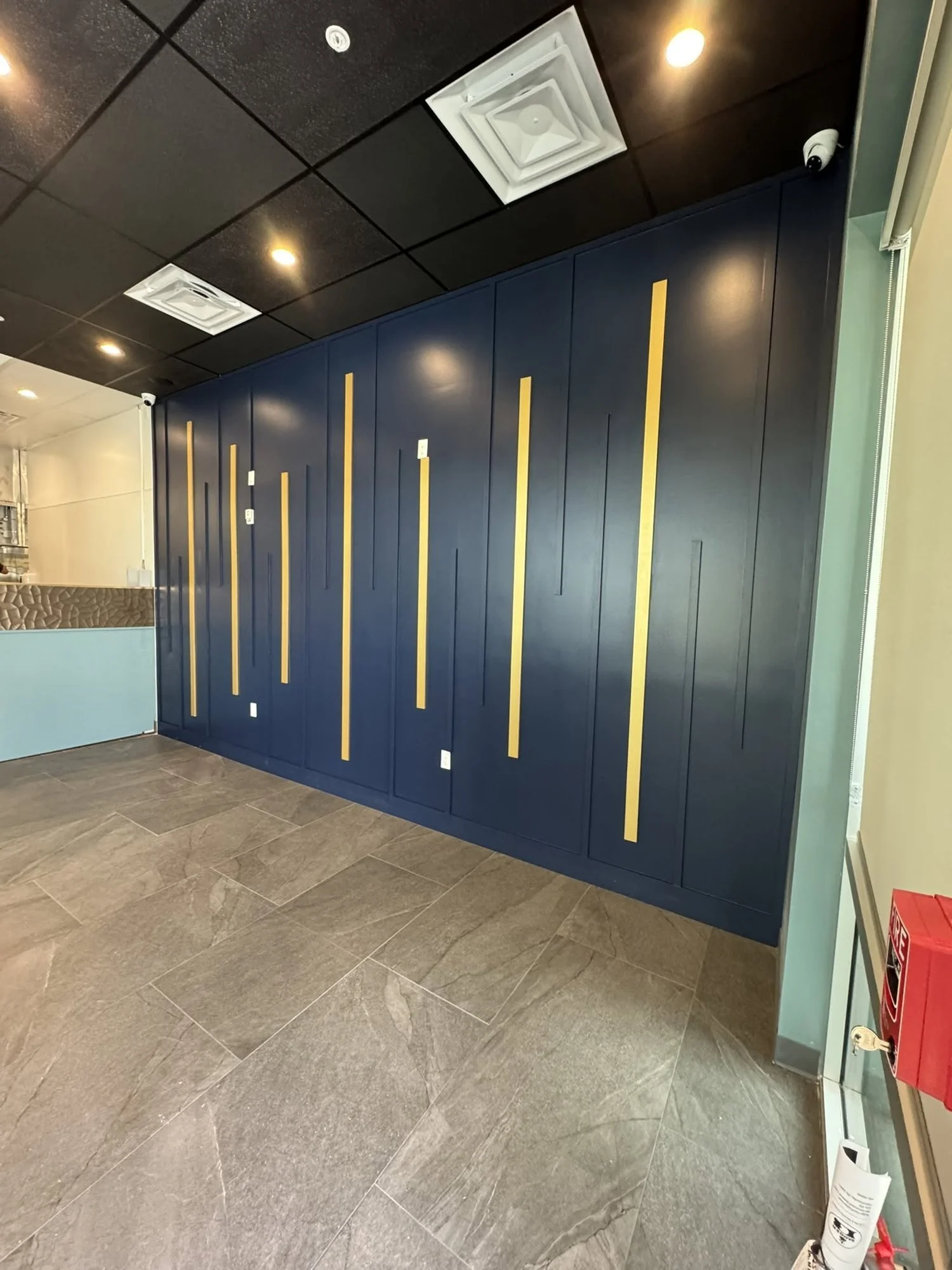Navy paneled accent wall with vertical wood strips