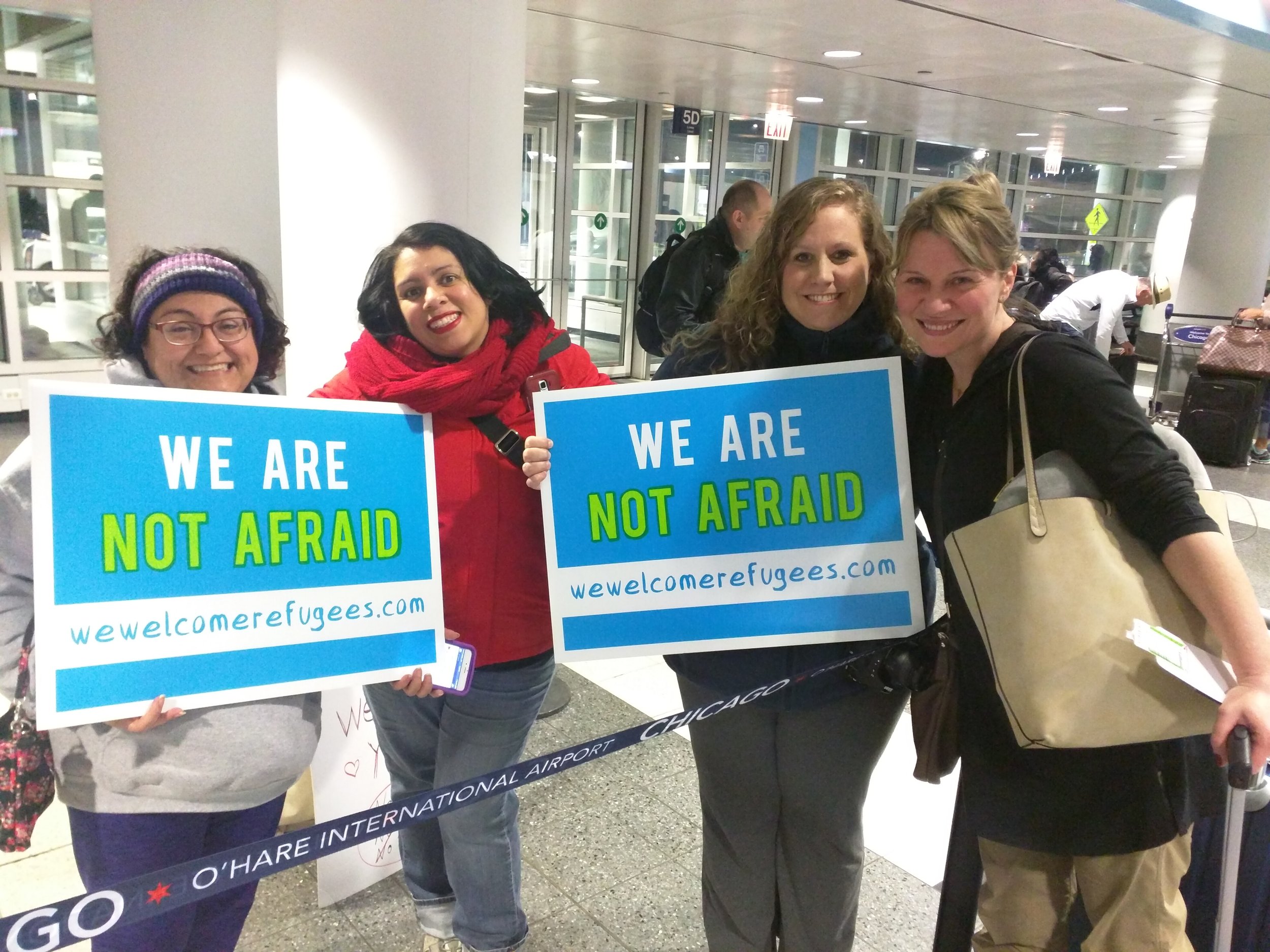 Chicago protesters (from left) Urzula Urzua, Ges Wernher, and Mahra Seward, welcome (right) Sara Ferrara, a UK native, moments after Judge Robart blocked Trumps travel ban. (Photo/Antonio Garcia)
