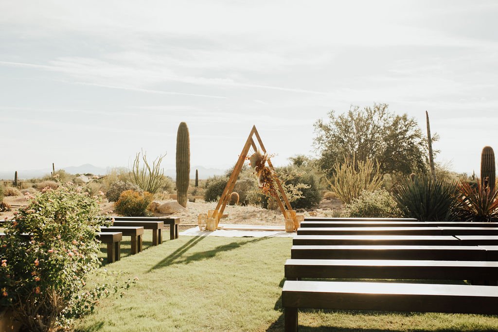 boho wedding ceremony space in desert with triangle altar
