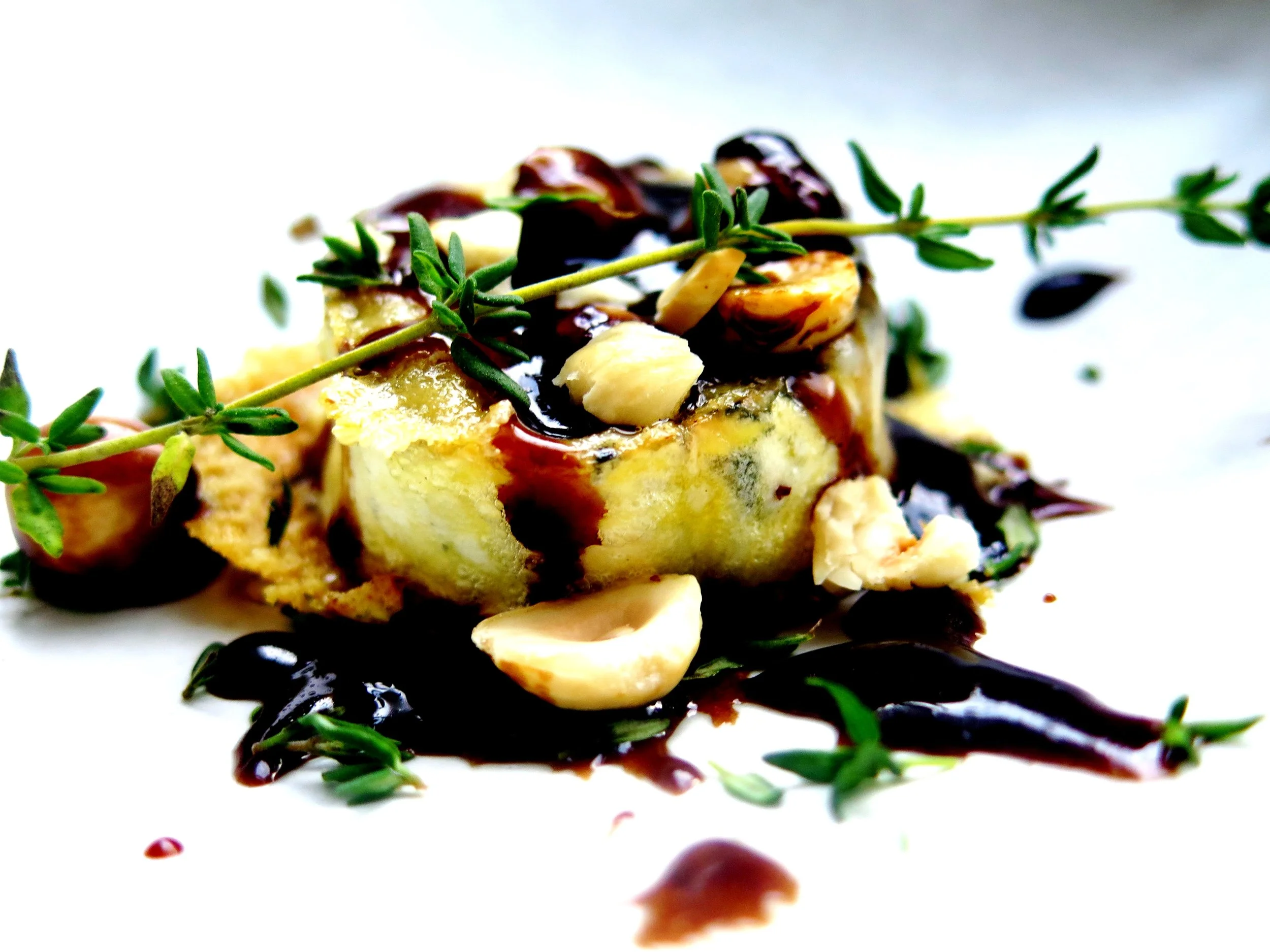 Crispy molten goat’s cheese with caramelised, thyme-infused maple balsamic and toasted hazelnuts