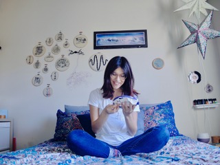 Lauren Hewitt at home, working on her latest stitching project. Photo by Sarah Davis.