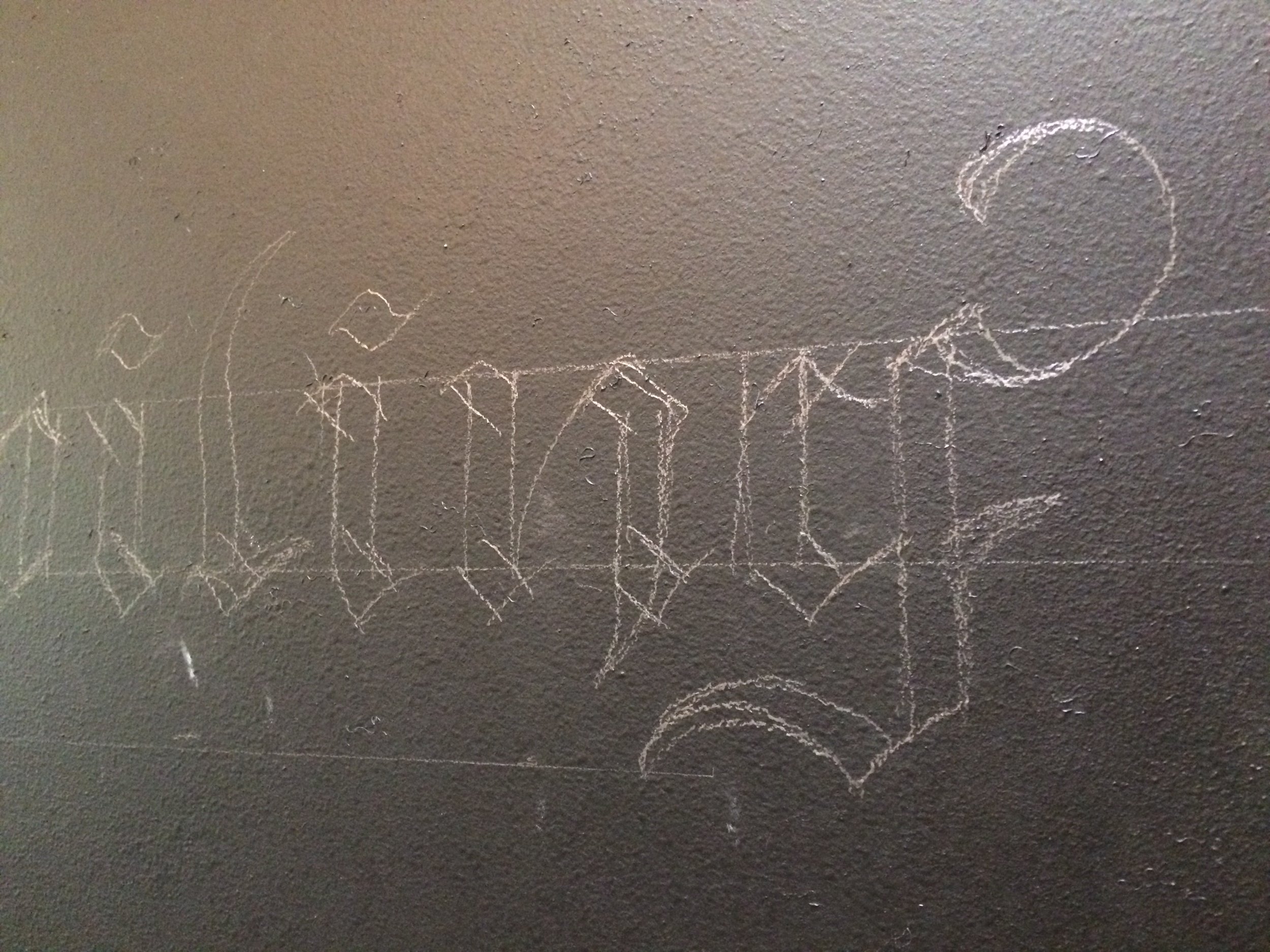 Close up of free hand lettering outlines before going over in chalk.