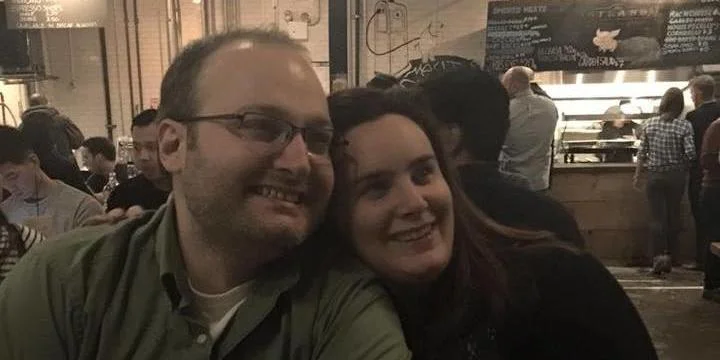 The happy couple enjoying BBQ, beers, and bluegrass at Astoria's Strand Smokehouse .