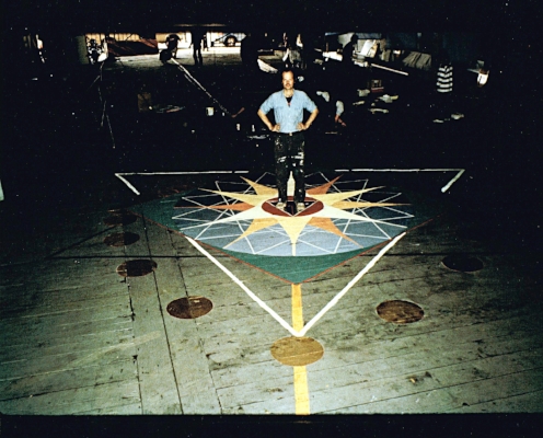 Installed on the floor of the Governor’s Island Ferry Terminal in 1981 as part of the installation of art for the Foot Ball, an art party celebrating the body-based logic of the foot-inch system of measurement. I have drawn dozens of these mandalas, generally by scratching into the earth someplace. Each time I begin by finding, as accurately as I can, a line on the earth parallel to the axis mundi, the meridian line – i visualize a specific line of longitude through whatever point i have decided is the center of the circle. And then, using sticks and string, i unfold the sacred geometry that manifests the pattern of life in that place, on those days when we gather.