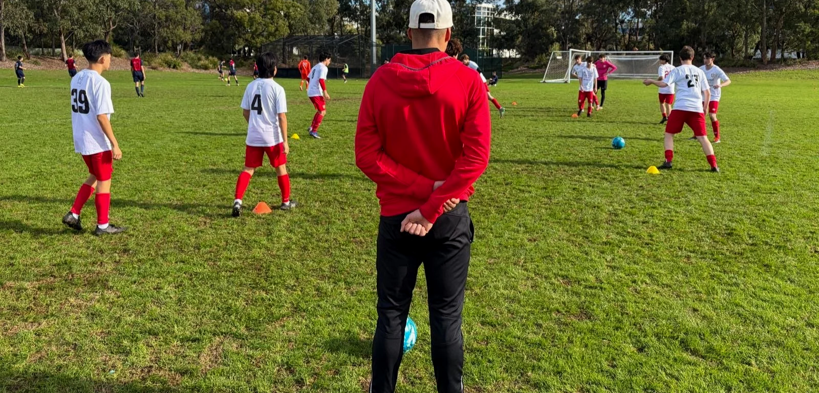 Coach overseeing warm ups