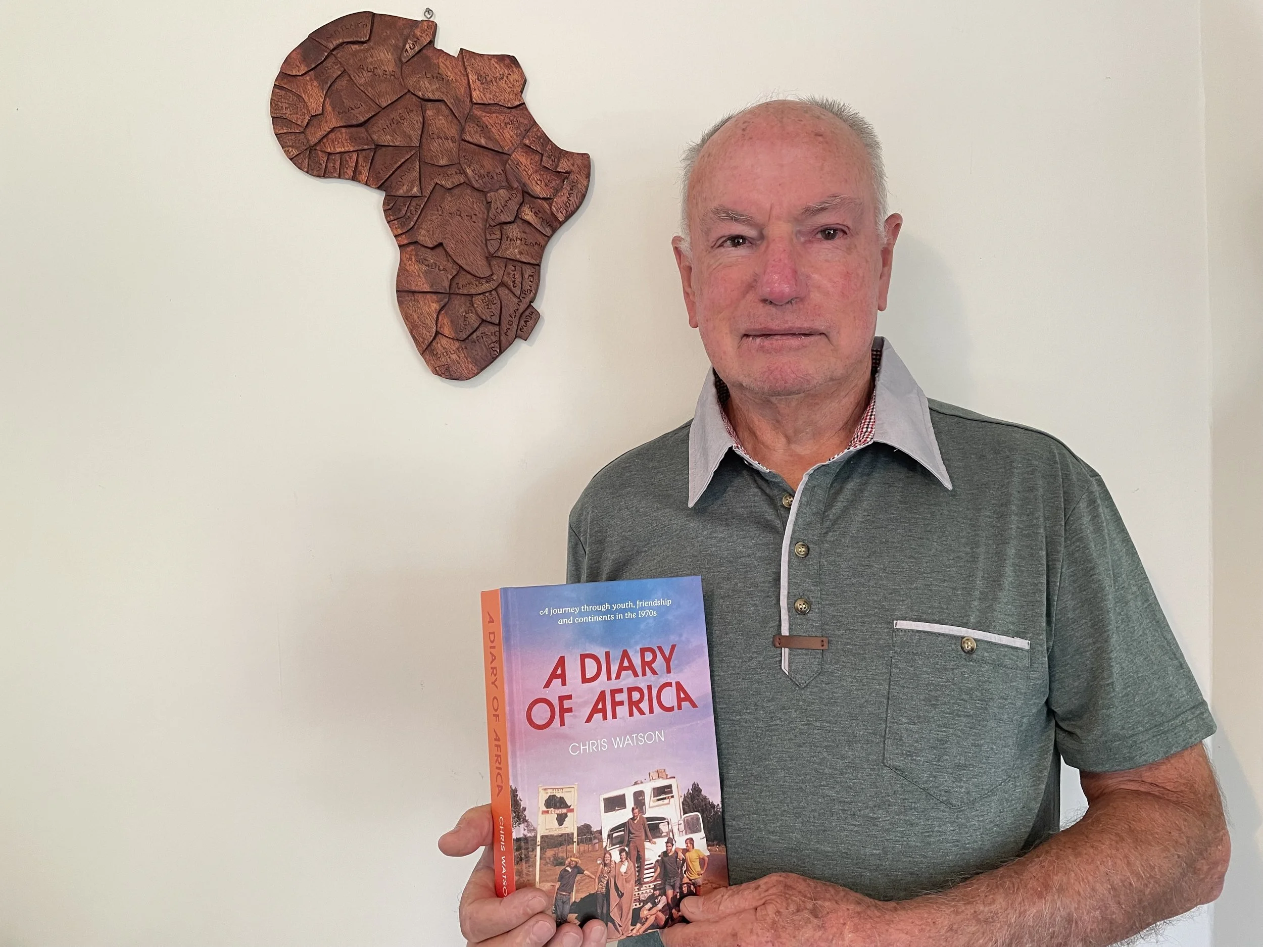 Chris Watson author photo with book.jpg.jpeg