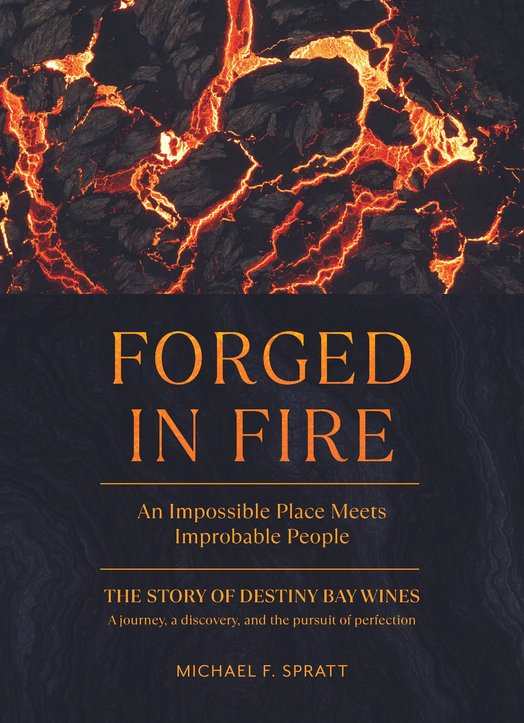 Book cover with a background of erupting lava and black volcanic rocks. Title reads 'Forged in Fire' in orange letters. Subtitle: 'An Impossible Place Meets Impossible People.' Additional text: 'The story of Destiny Bay Wines. A journey, a discovery,