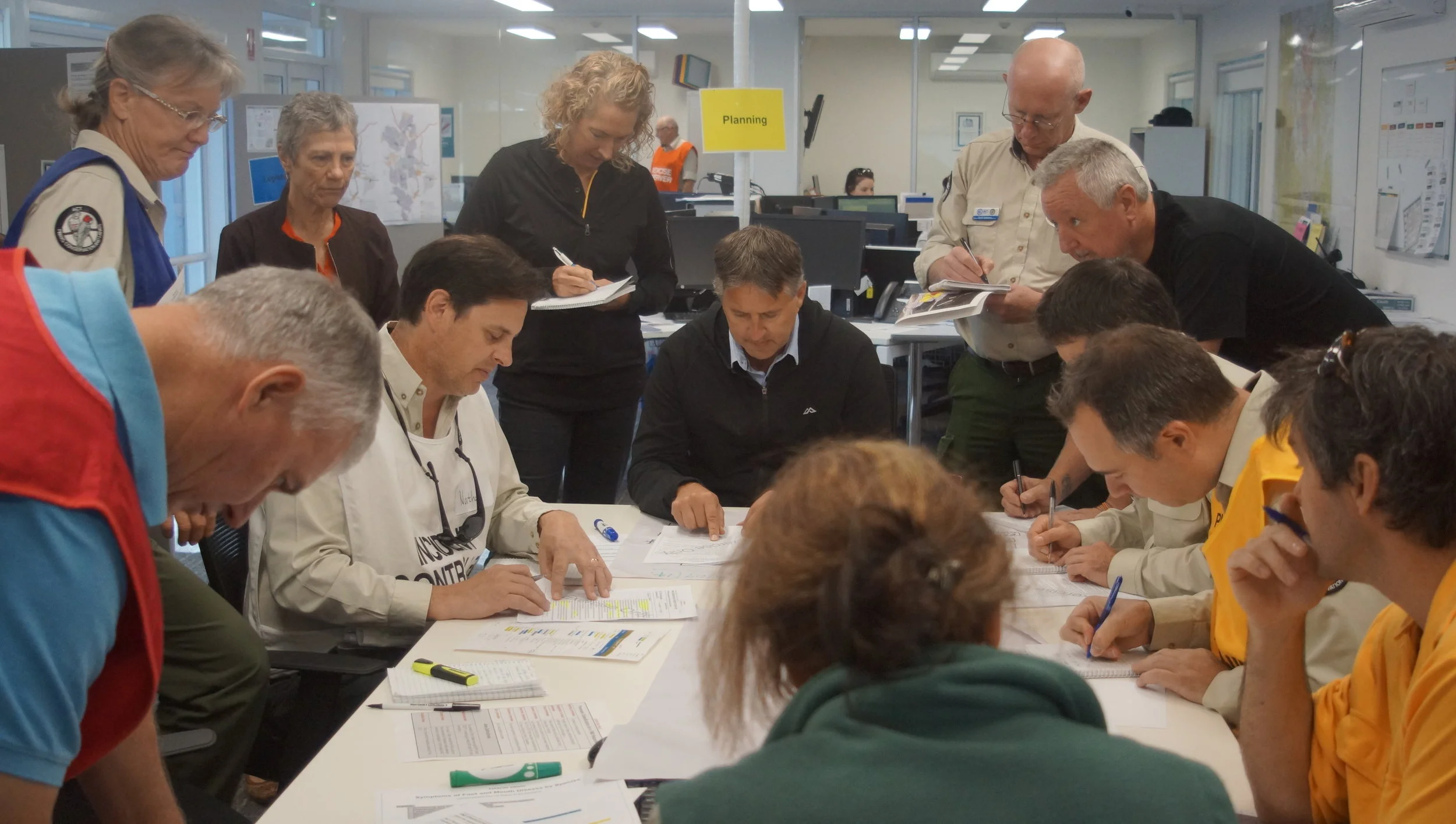 PHOTO: Team managers engaging in a mock briefing