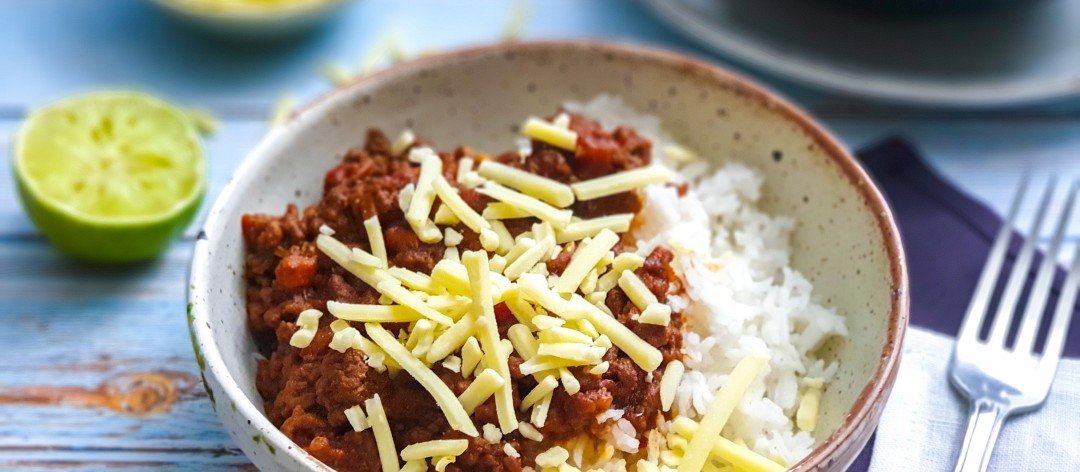 Bowl of hearty low FODMAP chilli con carne served with rice.