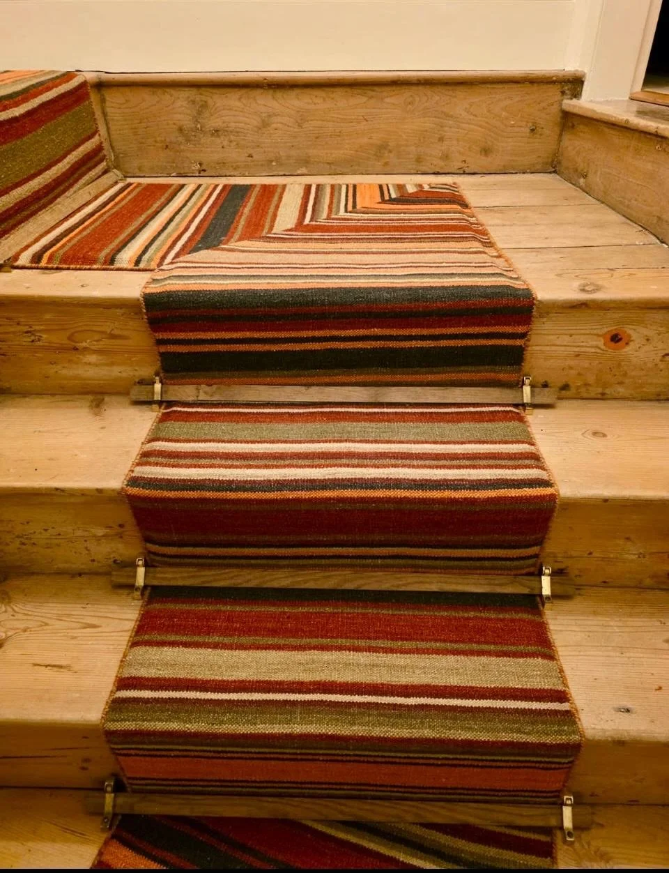 Stripes that make old stairs sing!

There is something deeply satisfying about seeing one of our bespoke runners being installed on stairs in a 17th century farmhouse with several corners, stripes to match up and old stairs to contend with - and it l