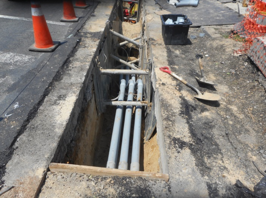 Installing conduit at the north-east corner of  Kansas Avenue and Missouri Avenue