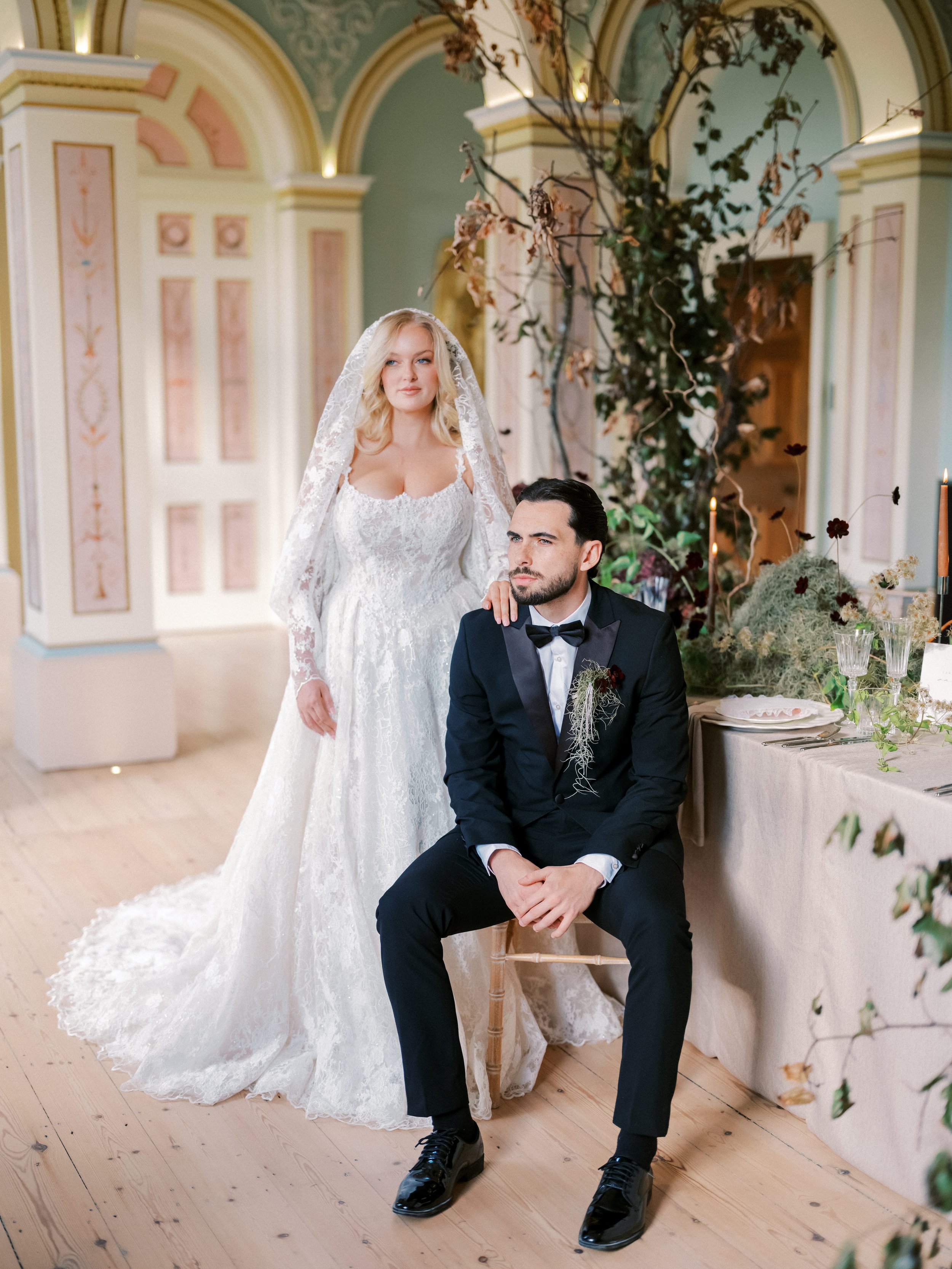 A wedding ceremony setup with white chairs and floral arrangements inside the light-filled White Chapel at Gloster House.