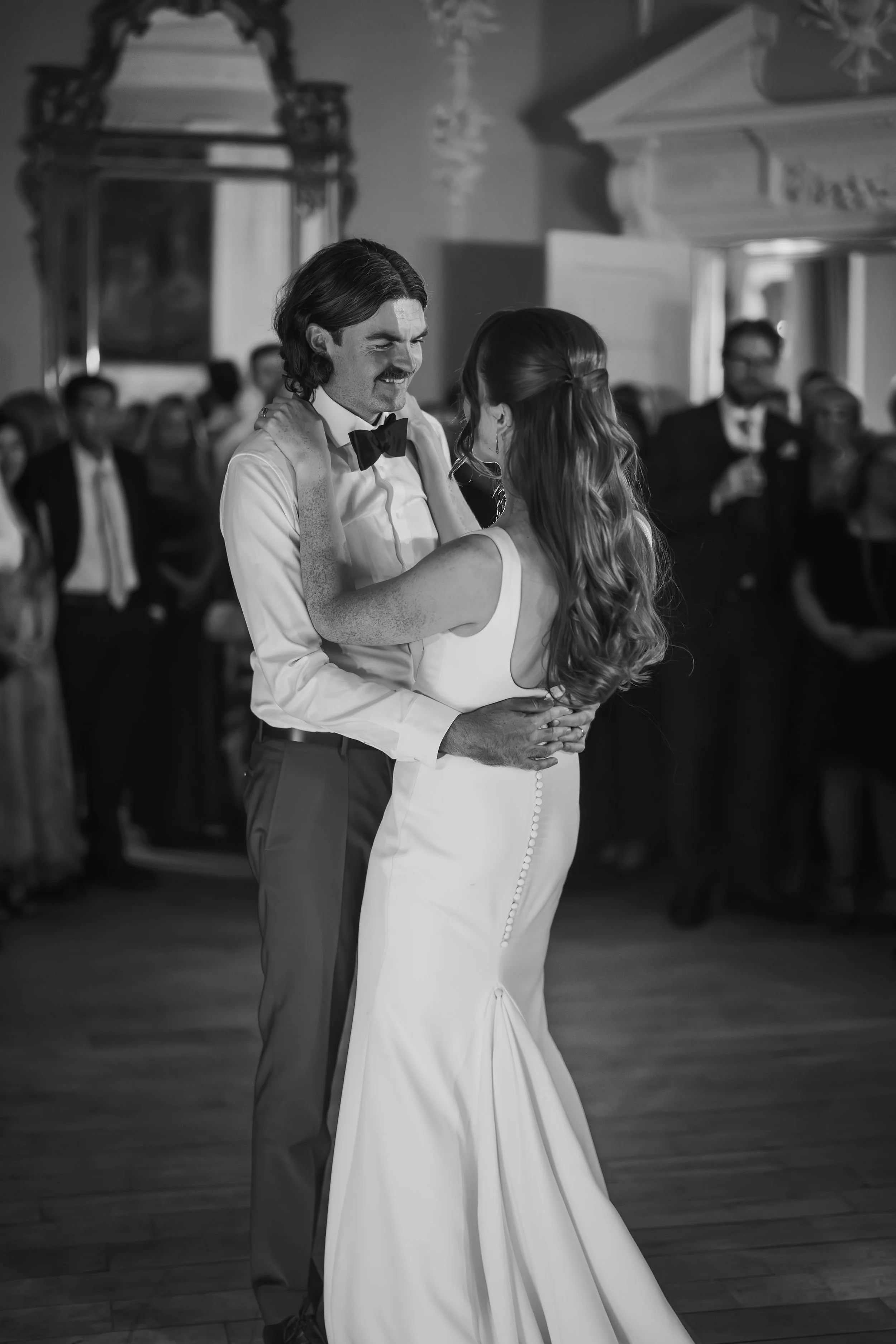 A romantic first dance outdoors in front of a historic Irish castle on the wedding day