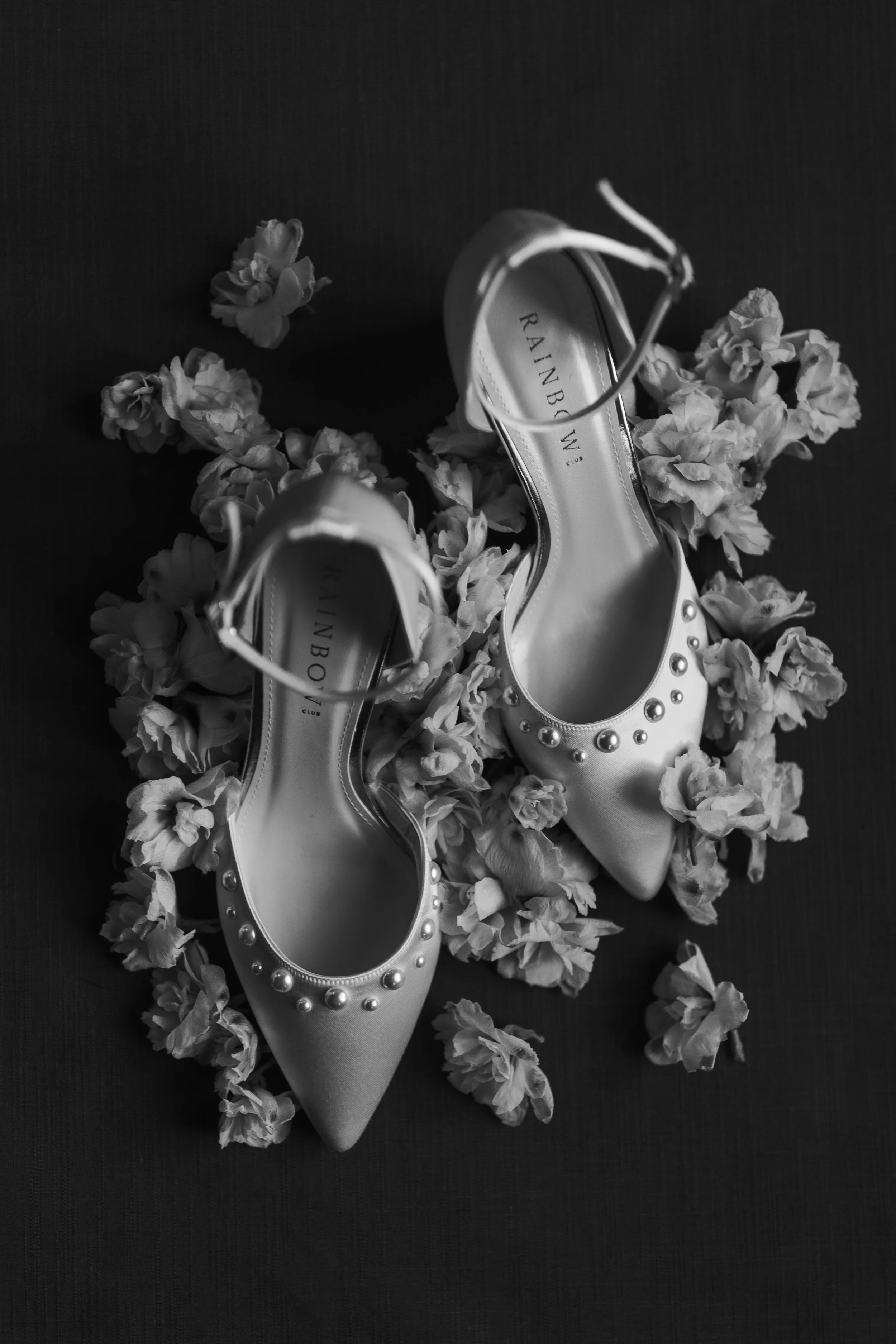flat lay black and white bridal shoes rainbow