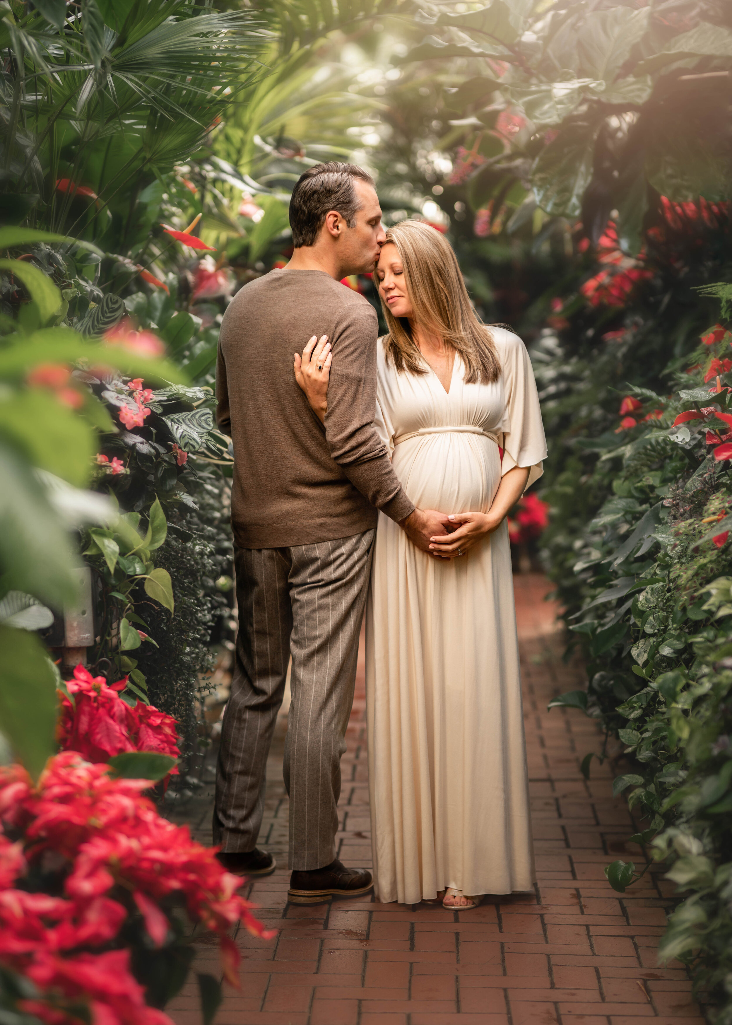 mom and dad to be at the Biltmore conservatory Asheville's Best Maternity Photographer