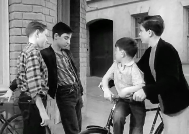 Beaver rides jauntily while Wally steers the bike, a very young HARRY SHEARER!