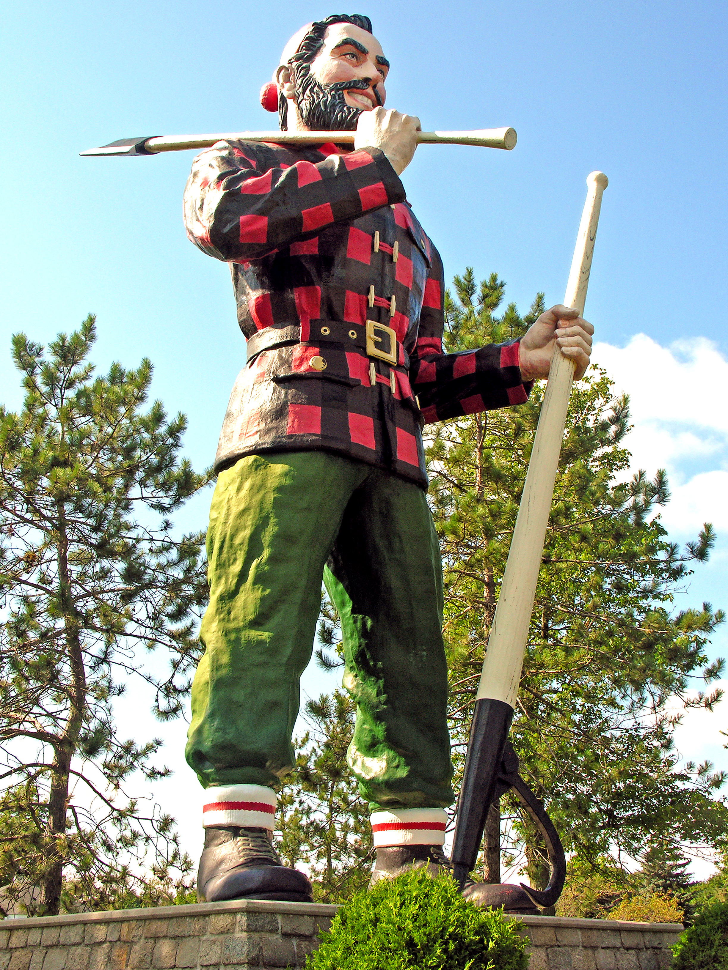 From RoadsideAmerica.com : Bangor's Paul Bunyan, "Reputed to be the largest statue of Paul Bunyan in the world," according to its sign, stands on a stone pedestal in front of the Bangor Civic Center in Bass Park. The statue is 31 feet high and weighs 3,700 pounds, not including its double-sided ax and peavey. Paul Bunyan's fiberglass-over-metal frame is hurricane-proofed to withstand 110 mph winds. Photo by Dennis Jarvis [CC BY-SA 2.0 via Wikimedia Commons