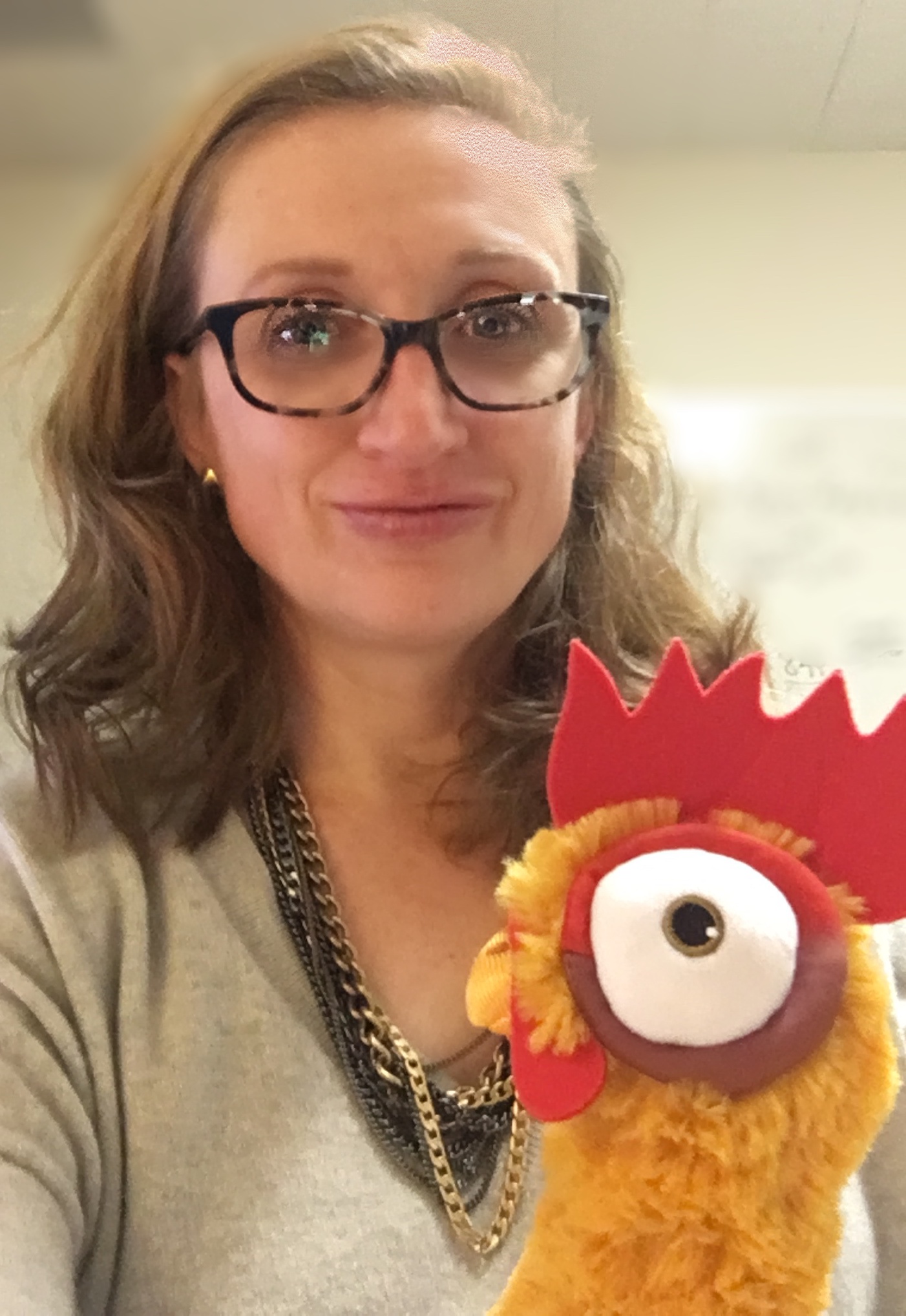 Marie Mayhew, wife, mother, CIA operator under deep hypnotic cover, and co-host of The Mad Scientist Podcast along with Dr. Cogswell. Pictured here with her stuffed Rooster "Heihei" who... um... I guess she says, "speaks to me."