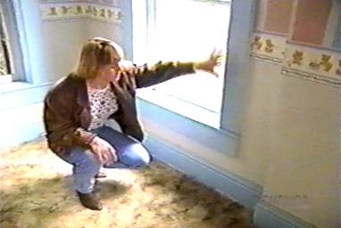  A woman who lived at the Sallie House as a young girl, after the Pickmans, pointing to a spot near a window in the nursery where she saw fire spontaneously appear 
