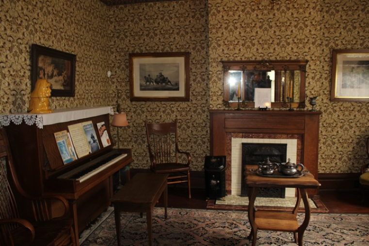Microphone that recorded F was positioned to the left of this photo, to the left of the chair and near the open doorway that led into the room where the Command Center was set up. REM Pod that begins beeping was sitting on the table in the middle of the room (amongst the tea set). Team members and Thurber House employee reported hearing the REM Pod, but not the footsteps/door/unknown voice. This microphone was also the closest to the team members and Thurber House employee, so it stands to reason that if any of those noises were the result of those people, it would have been the loudest on this microphone. DVR camera, which was positioned immediately behind the microphone that recorded F shows no one in the room at the time the footsteps/door/unknown voice were recorded.