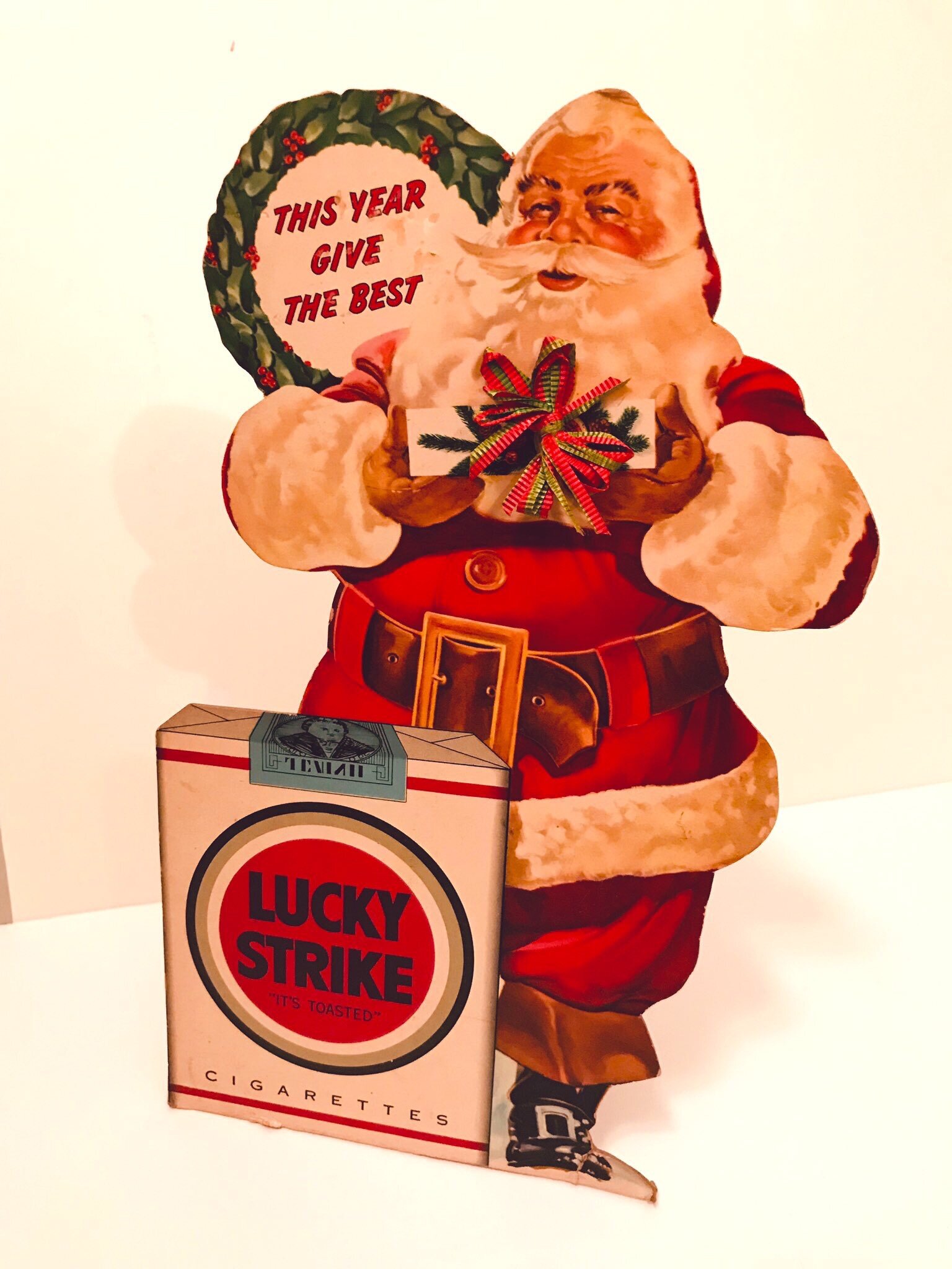  A 1940s cardboard standee of Santa advertising Lucky Strike cigarettes  