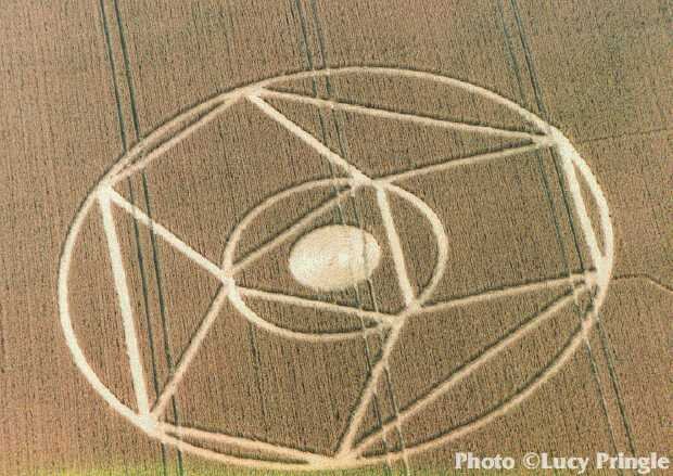  Winterbourne Bassett, Wiltshire, July 23, 1995.  “A complex '3D hypercube' formation consisting of a central ring with three lines forming an equilateral triangle inside it.”  Photo: © Lucy Pringle 1990 