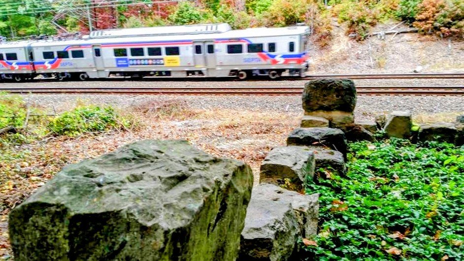  An Amtrak train passing the stone wall at Duffy's Cut 