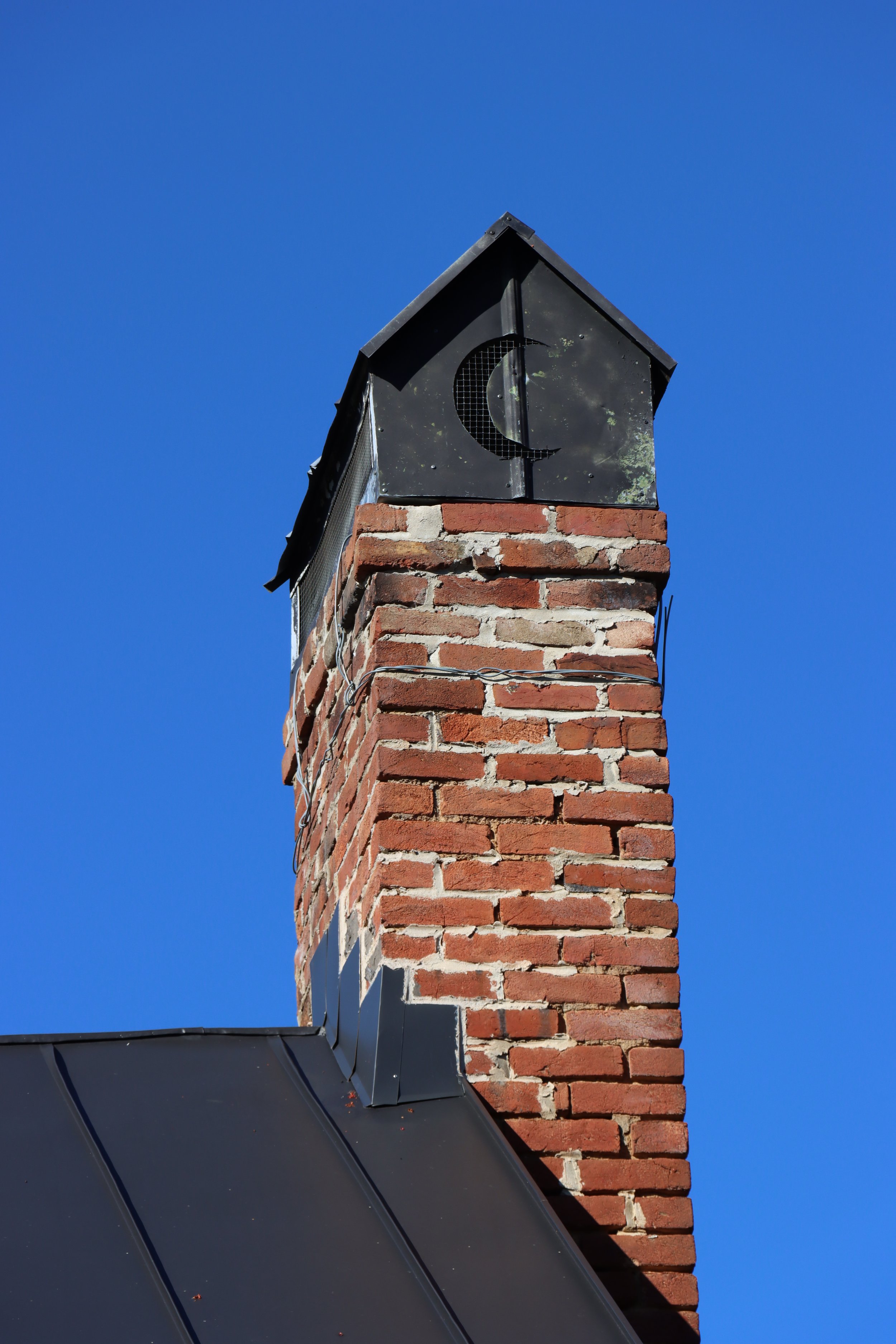  The chimney from a Middleway, WV home shows the enduring and pervasive symbol of the crescent shape made by the Wizard Clip. 