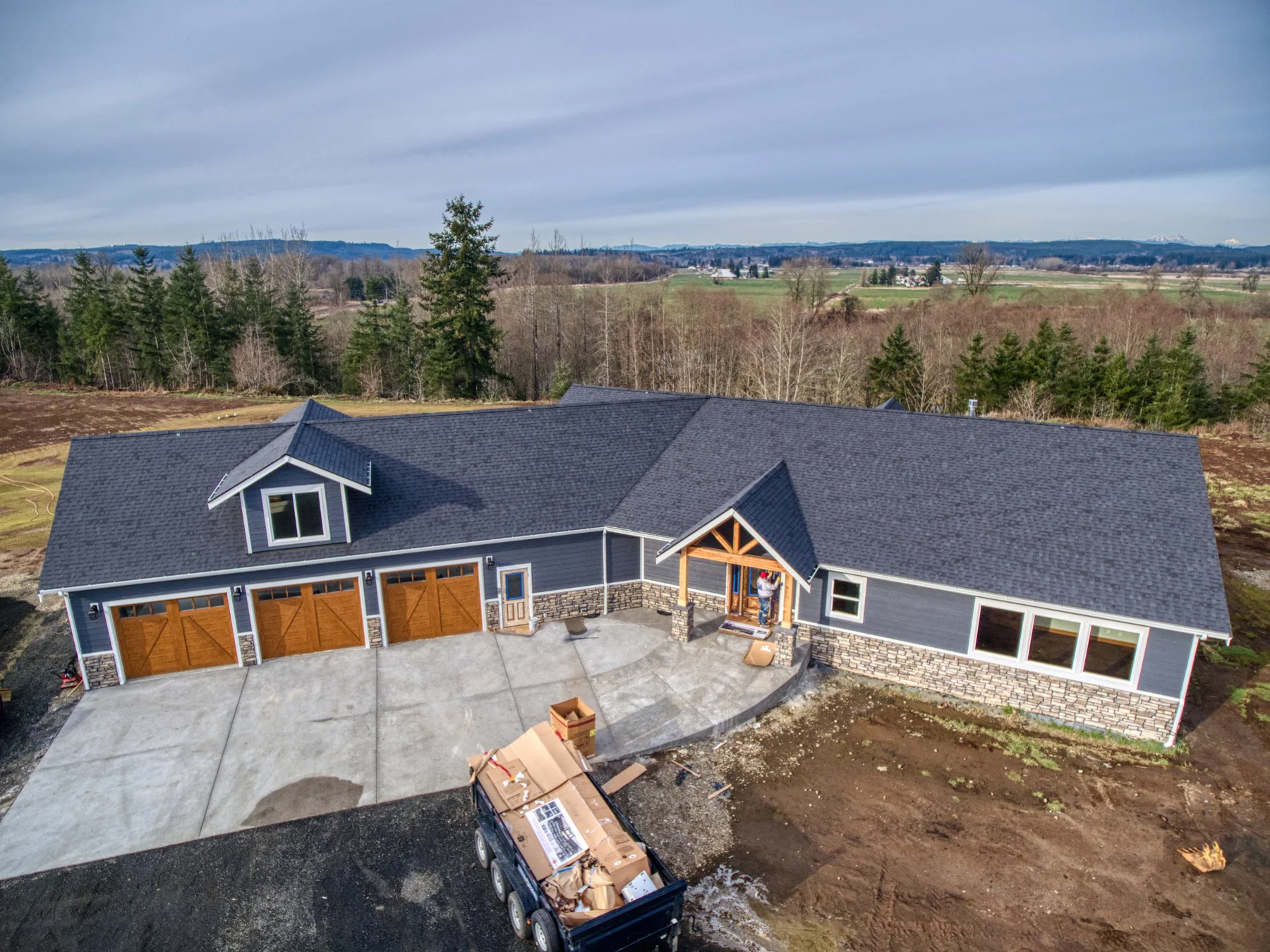 Blake's craftsman custom home near Satsop featuring timber frame covered entry with stone accents - FoxHead Construction Grays Harbor County