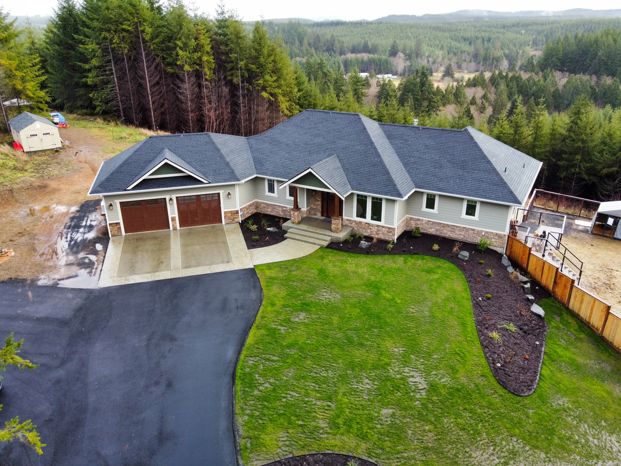 Stephen's custom home in Elma featuring multi-level design with wraparound decks on hillside acreage - FoxHead Construction Grays Harbor County
