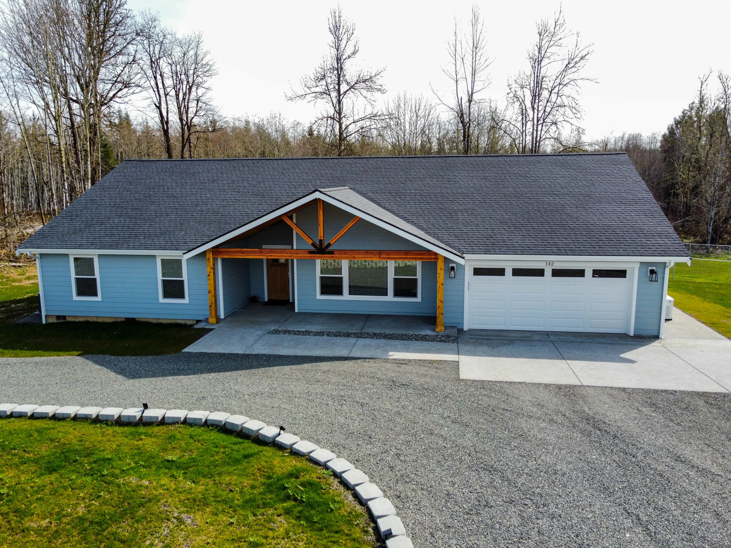 Jim's modern craftsman ranch custom home in Centralia featuring timber frame covered porch - FoxHead Construction Lewis County