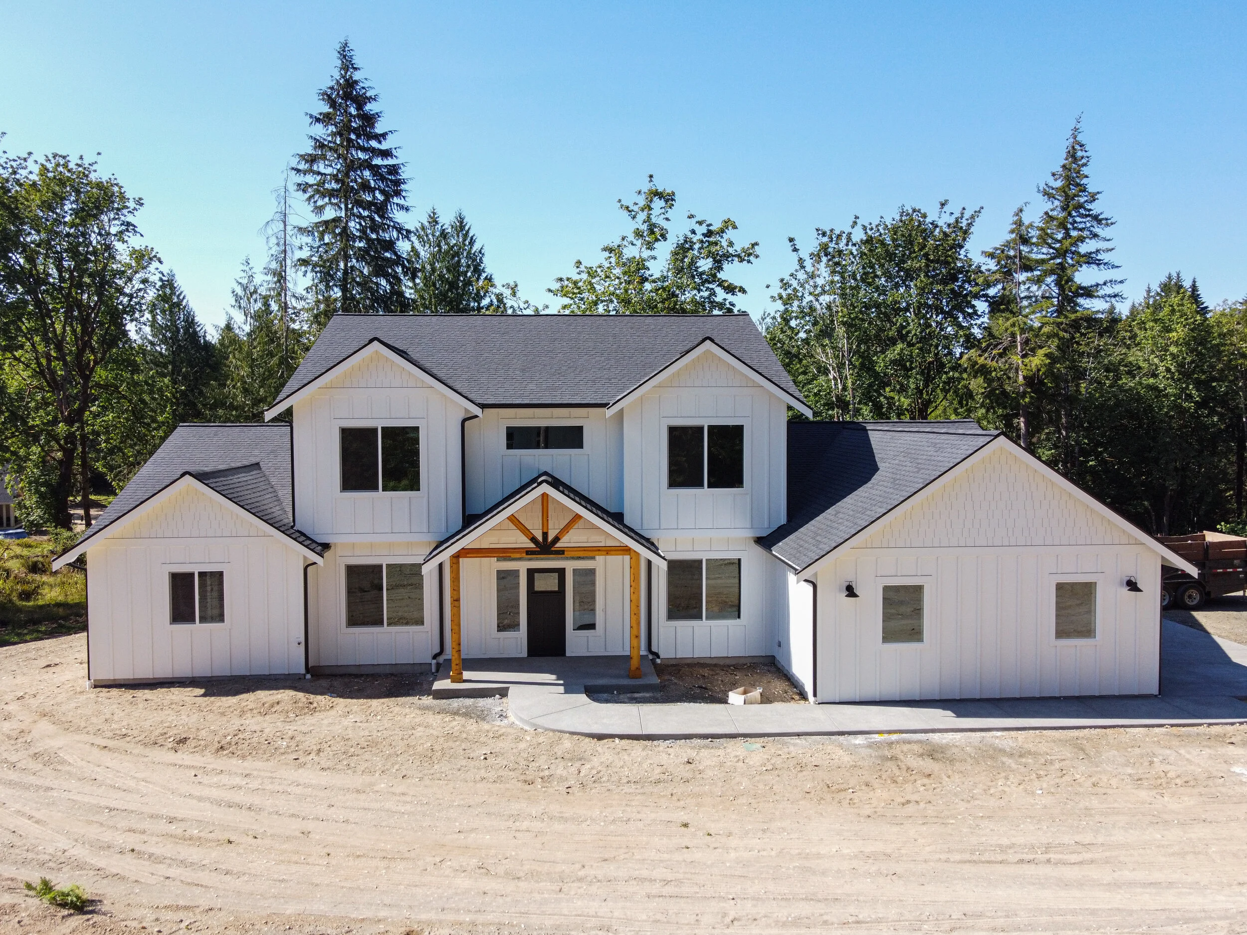 Clark's modern farmhouse custom home in Steamboat Island area - white exterior with timber frame entry - FoxHead Construction Thurston County