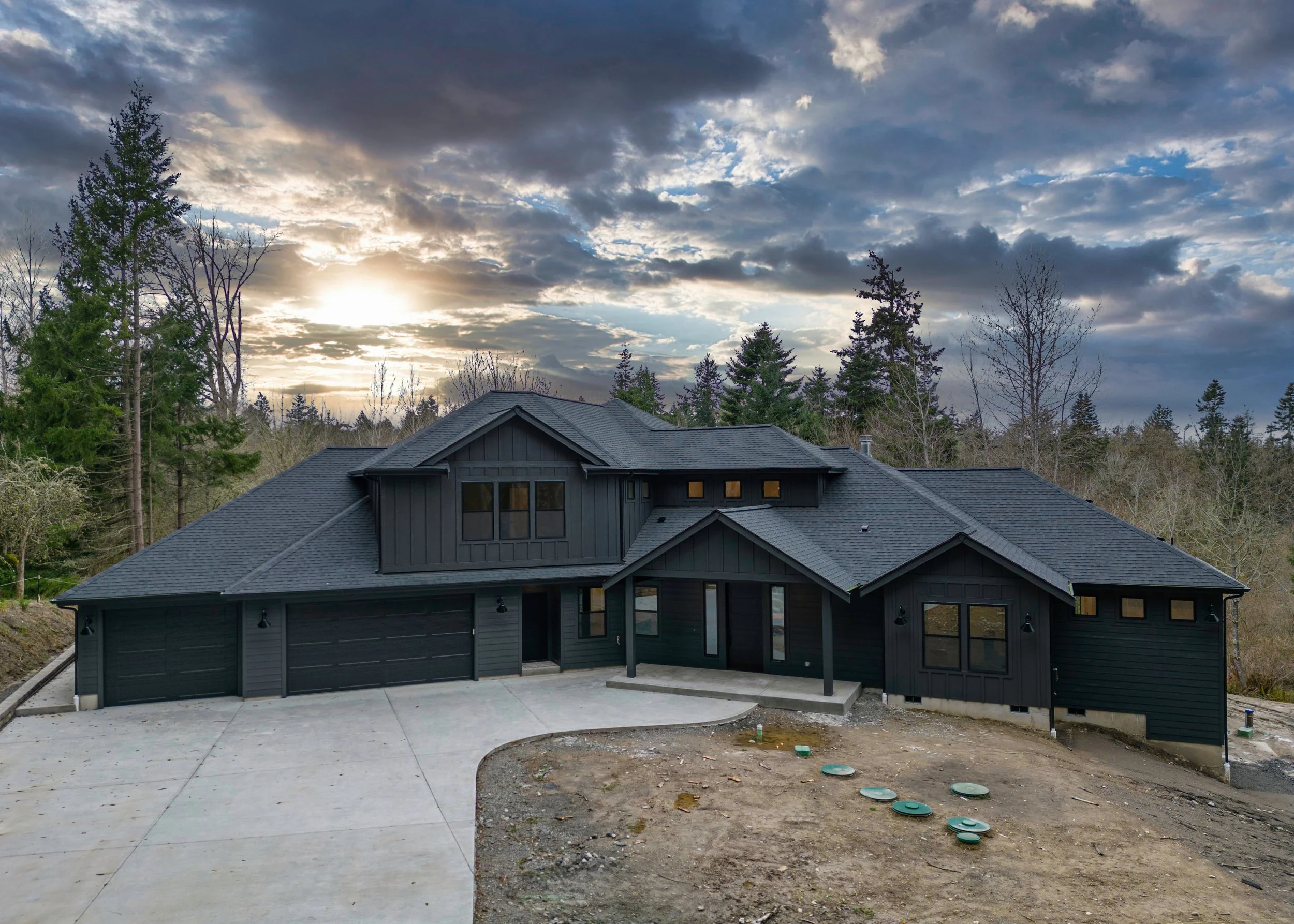 Clark's modern custom home in Olympia featuring iron exterior with multi-level deck system - FoxHead Construction Thurston County